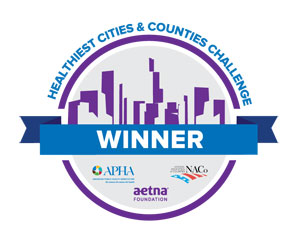 Healthiest Cities & Counties Challenge WINNER, cityscape, APHA, Aetna Foundation, NaCo logos